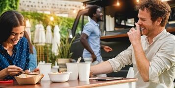 Young,People,Having,Fun,Eating,At,Food,Truck,Restaurant,Outdoor