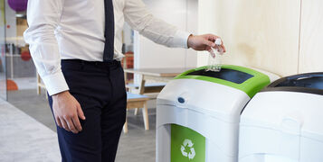 Man,In,An,Office,Throwing,Plastic,Bottle,Into,Recycling,Bin